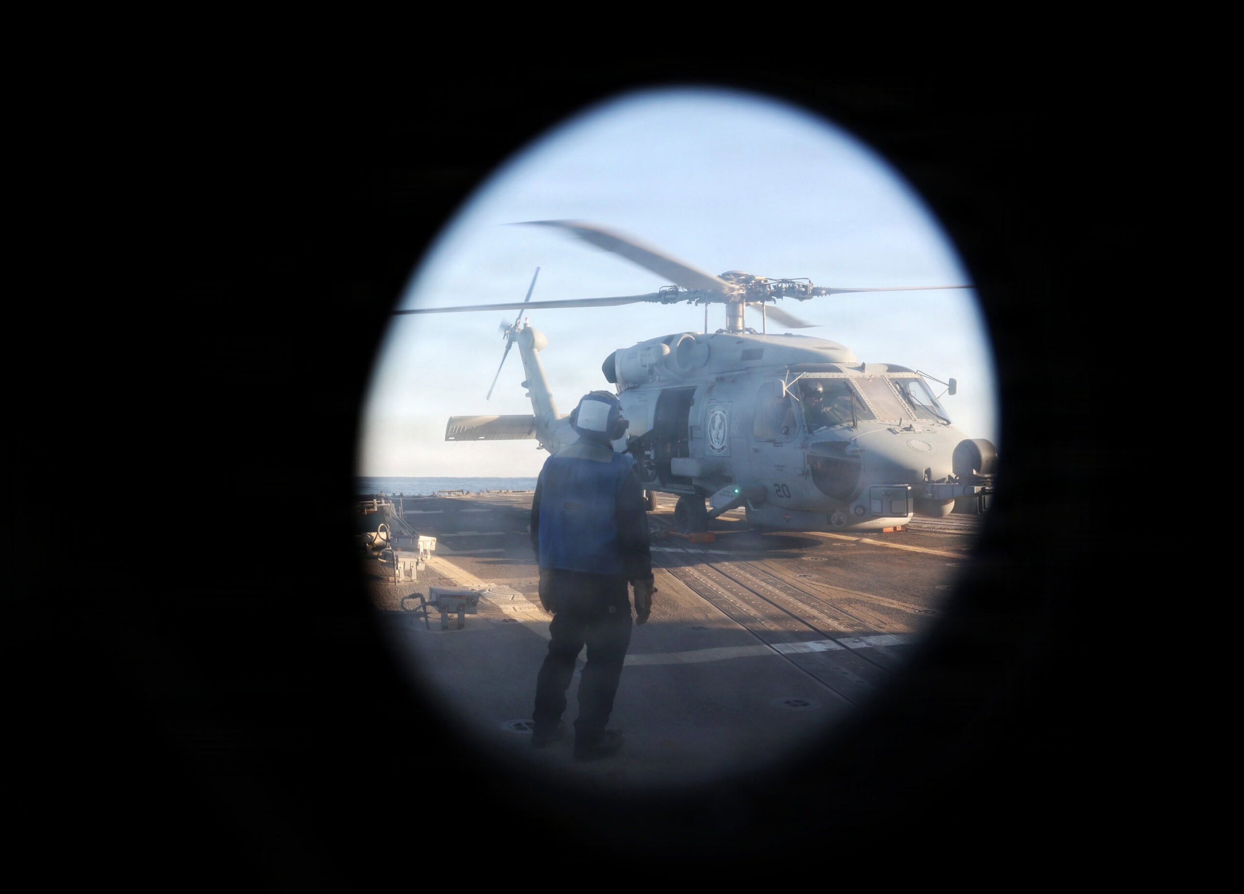 STRAIT OF HORMUZ (Jan. 8, 2026) A U.S. Sailor, assigned to the Arleigh Burke-class guided-missile destroyer USS Roosevelt (DDG 80), observes an MH-60R Sea Hawk, assigned to Helicopter Maritime Strike Squadron (HSM) 79, during flight operations in the Strait of Hormuz. Roosevelt is deployed to the U.S. 5th Fleet area of operations to support maritime security and stability in the U.S. Central Command area of responsibility. (U.S. Navy photo by Mass Communication Specialist 1st Class Indra Beaufort)