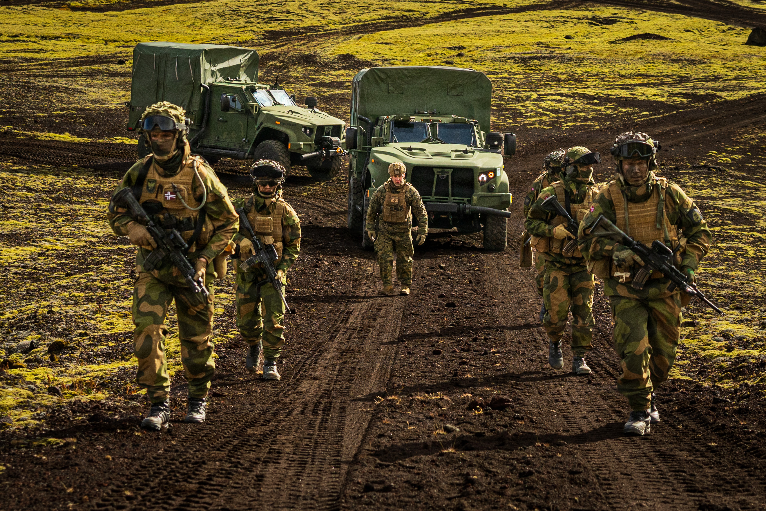 Norwegian Home Guard soldiers escort U.S. Marine Corps Joint Light Tactical Vehicles during a tactical displacement in Jan Mayen, Norway, on Aug. 30, 2026. (Sgt. Noah Masog/U.S. Marine Corps)