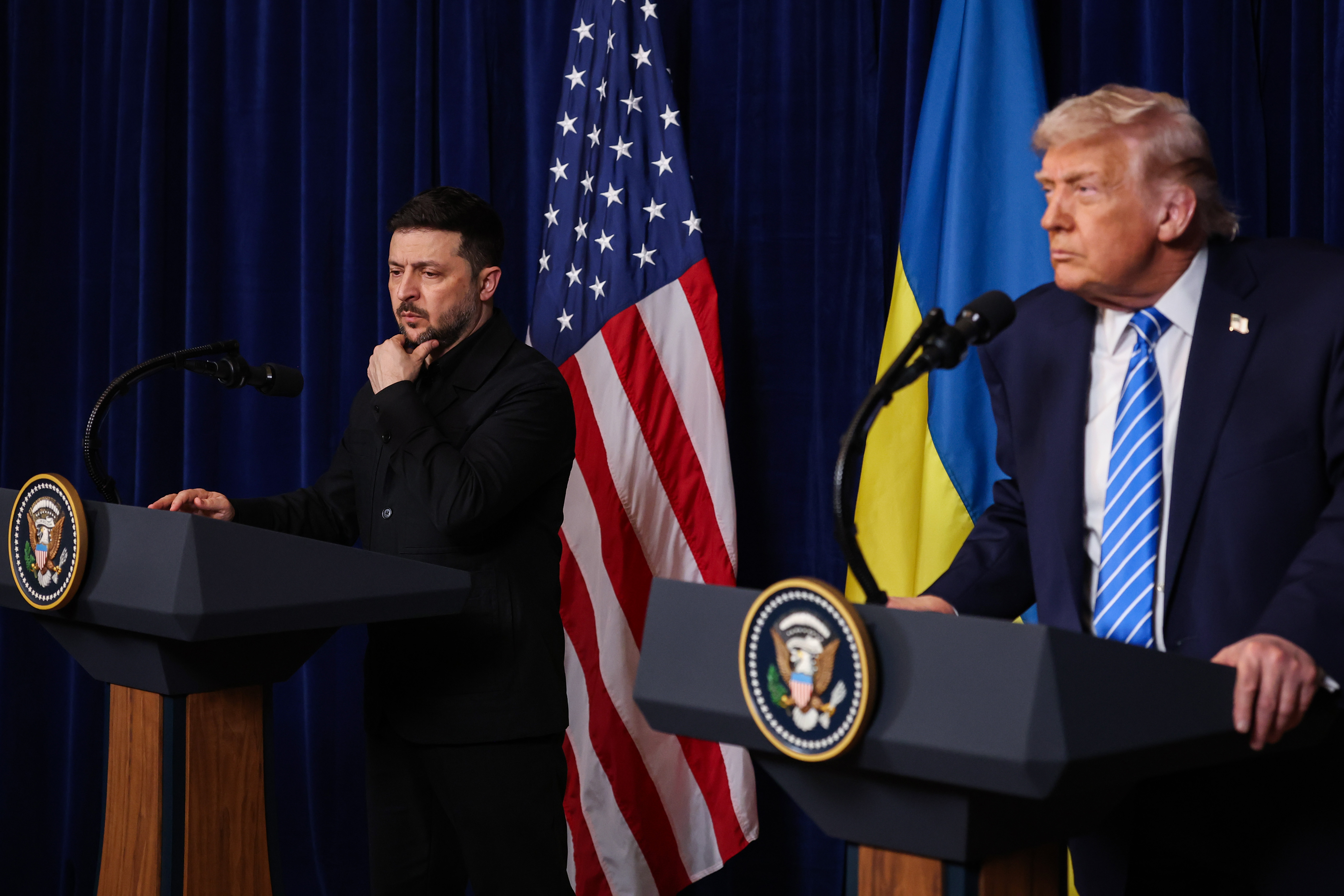 Ukrainian President Volodymyr Zelensky listens as U.S. President Donald Trump speaks during a press conference following their meeting at Trump’s Mar-a-Lago club on Dec. 28, 2025. (Joe Raedle/Getty Images)