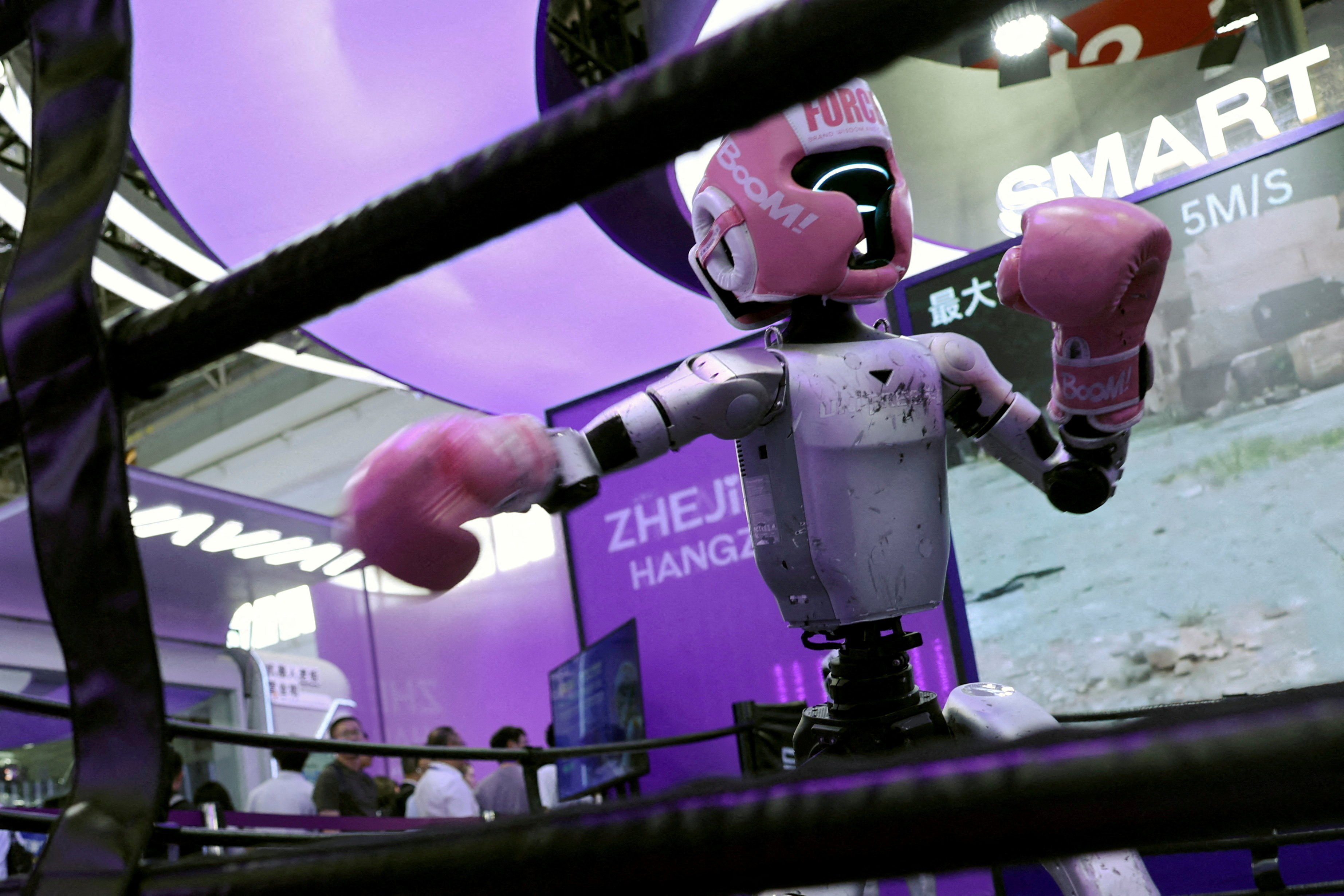 A Unitree humanoid robot demonstrates kickboxing moves during the China International Supply Chain Expo in Beijing on June 22, 2026. (Florence Lo/Reuters)