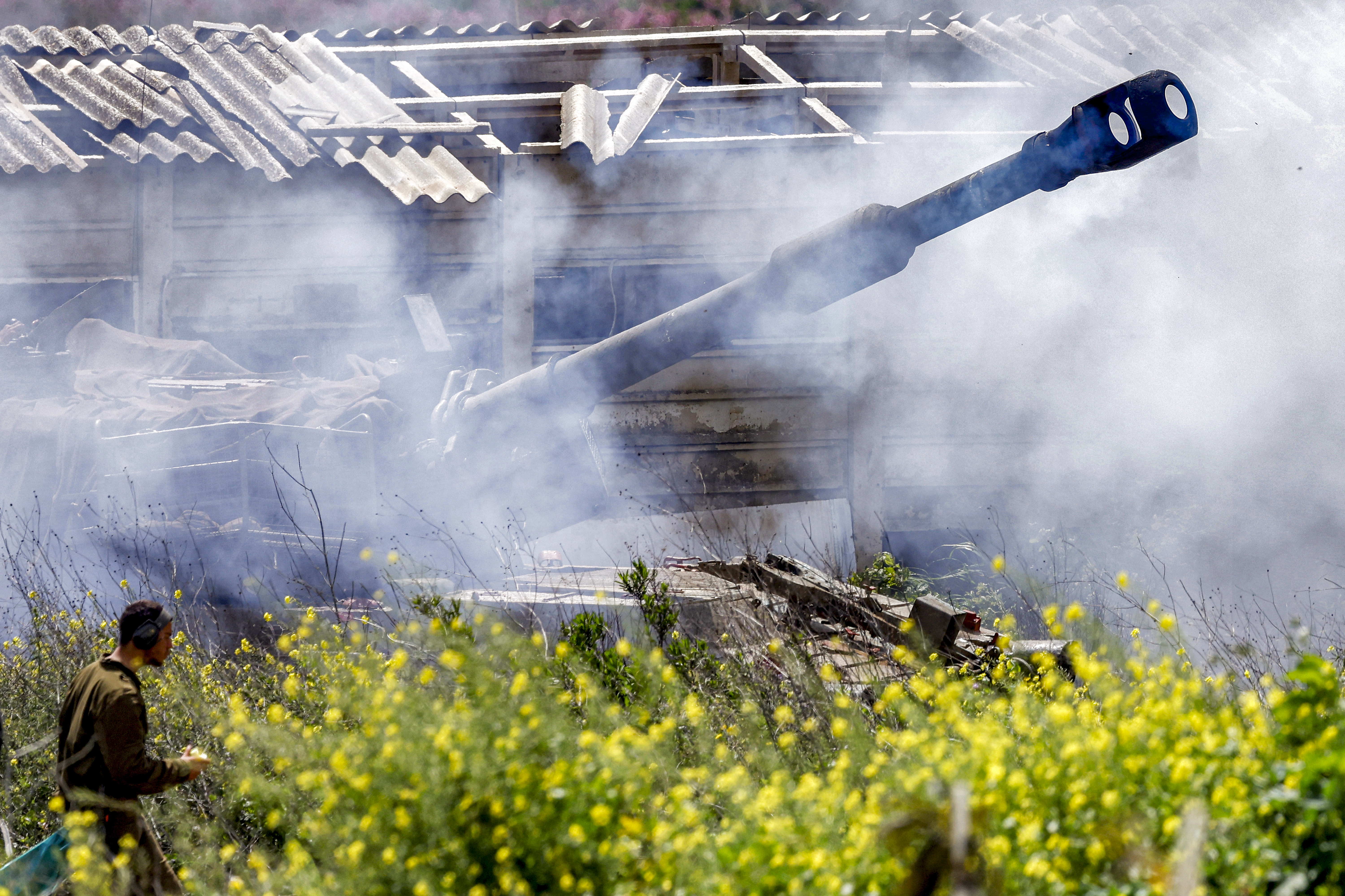 Smoke is released after an Israeli army self-propelled howitzer fires rounds from the upper Galilee in northern Israel near the border with southern Lebanon on March 27, 2026. (Jalaa Marey / AFP via Getty Images)