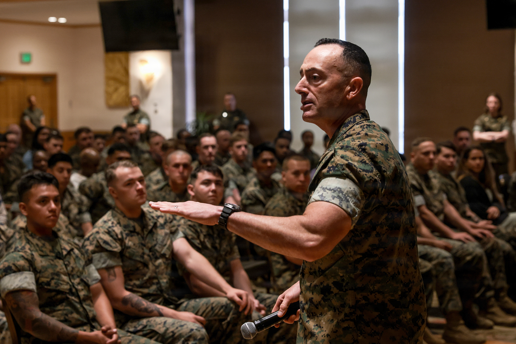 U.S. Marine Corps Sgt. Maj. Christopher Adams, a native of Georgia and the sergeant major of III Marine Expeditionary Force, speaks at a suicide prevention symposium at Camp Hansen, Okinawa, Japan, April 16, 2026. Adams spoke at a suicide prevention symposium, discussing leadership, troop welfare and the quality of life of on base personnel. (U.S. Marine Corps photo by Lance Cpl. John-Paul Haubeil)