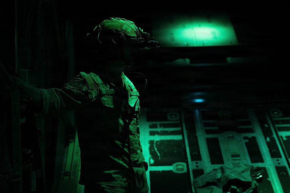 A U.S. Air Force special missions aviator calibrates night-vision goggles during a MC-130J Commando II flight over America’s Southeast region, Oct. 7, 2025. NVGs amplify existing ambient light or detect infrared radiation to produce an image visible to the human eye in low-light or dark conditions, ensuring Air Commandos can effectively conduct covert night operations. (U.S. Air Force photo by Airman 1st Class Samantha Rossi)