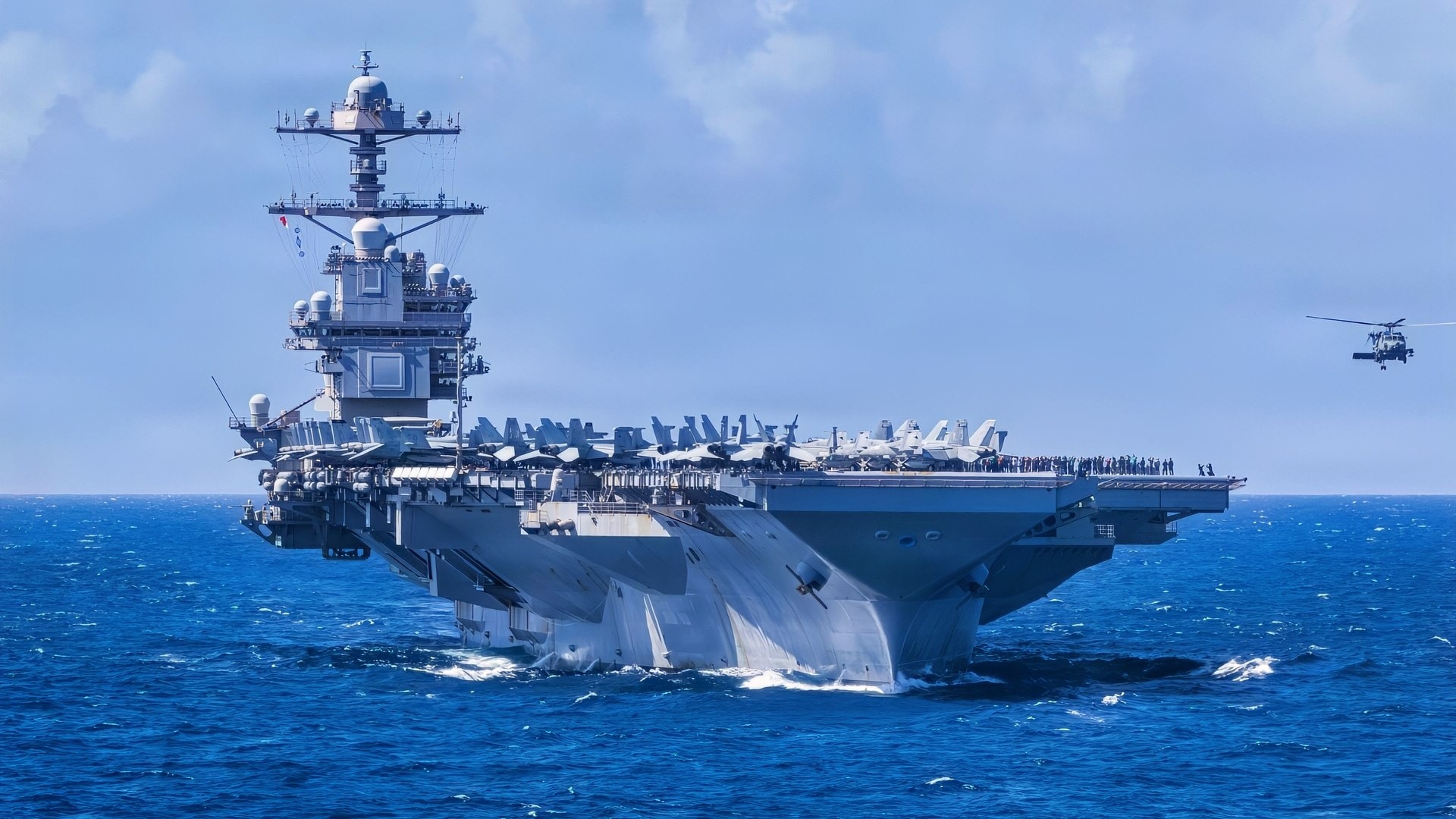 U.S. Navy Carrier Air Wing 8 aircraft fly in formation over the world’s largest aircraft carrier, Ford-class aircraft carrier USS Gerald R. Ford (CVN 78), during Carrier Air Wing 8’s aerial change of command ceremony while underway in the Caribbean Sea, Jan. 19, 2026. U.S. military forces are deployed to the Caribbean in support of the U.S. Southern Command mission, Department of War-directed operations, and the president’s priorities to disrupt illicit drug trafficking and protect the homeland. (U.S. Navy photo)