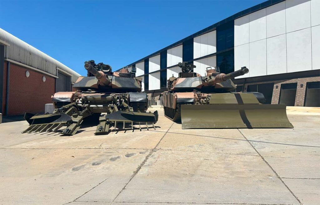M1A2 SEP V3 MBTs, destined for the Polish Armed Forces, have been equipped with track-width mine ploughs, as well as combat dozer blades from Pearson Engineering. [Pearson Engineering]