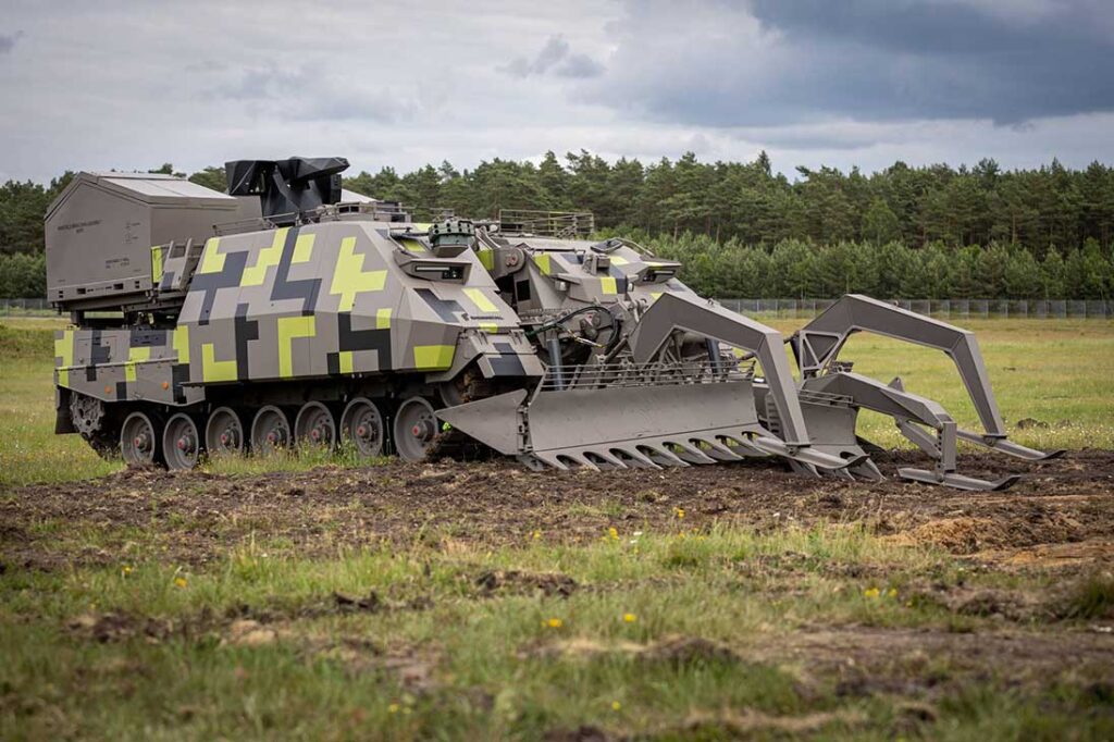 Rheinmetall’s Keiler NG can carry a mine plough mounted on the front of the hull and two launchers for the Plofadder MICLIC system mounted in boxes on top of the hull rear. [Rheinmetall]