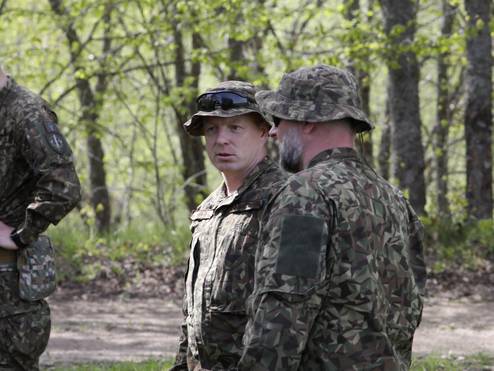 Lt. Col. Andris Brūveris, center, commander of Latvia's 2nd Mechanized Infantry Battalion, speaks with staff at the Sēlija training area on May 11, 2026, during the Crystal Arrow 2026 exercise. (Rudy Ruitenberg/staff)