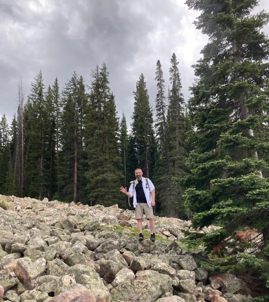 Casey Elliott climbing toward a memorial hut during a 2022 veterans retreat in Colorado. (Photo courtesy of the author)