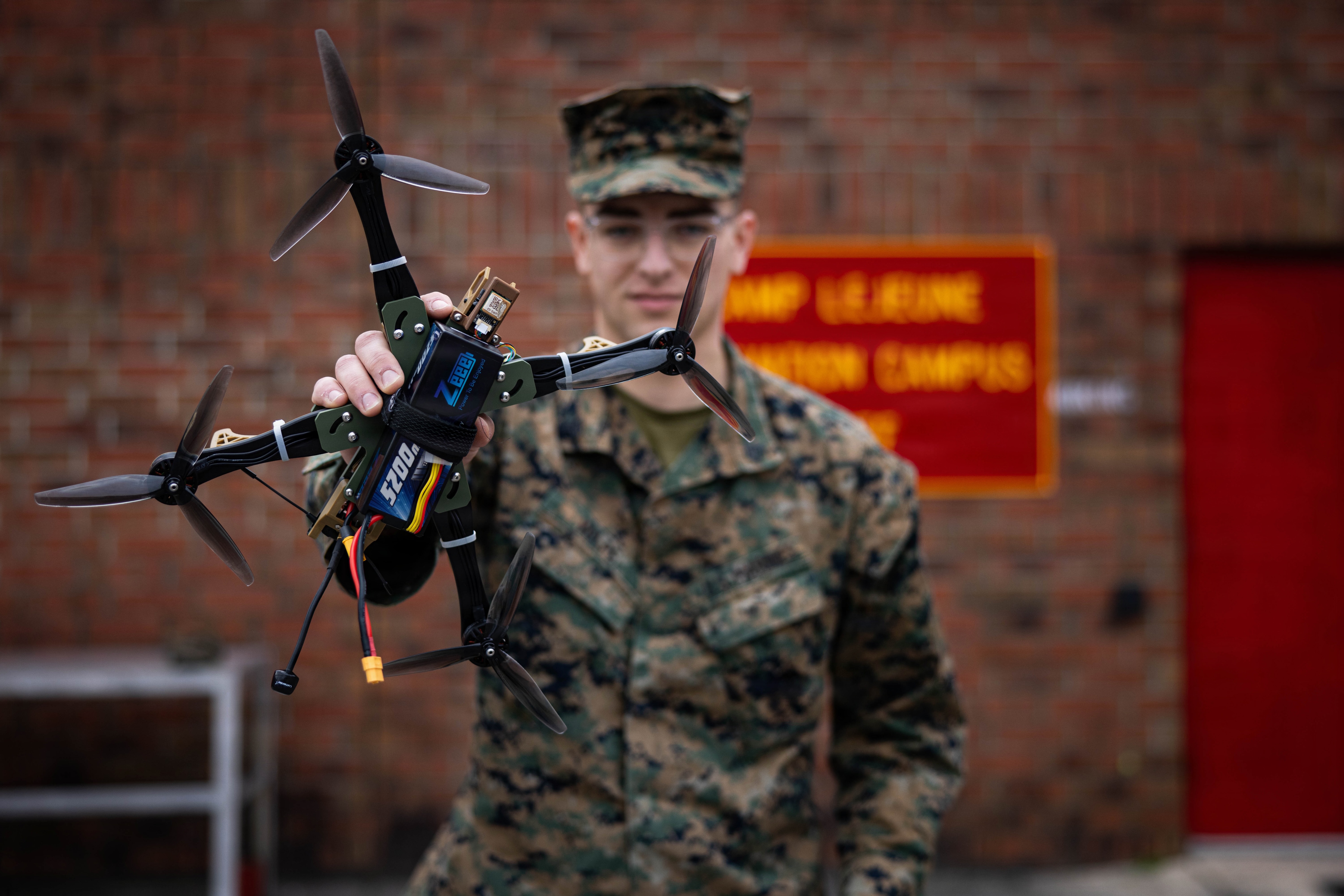 Volpe poses for a photo with the HANX drone he designed. (Sgt. Alfonso Livrieri/U.S. Marine Corps)