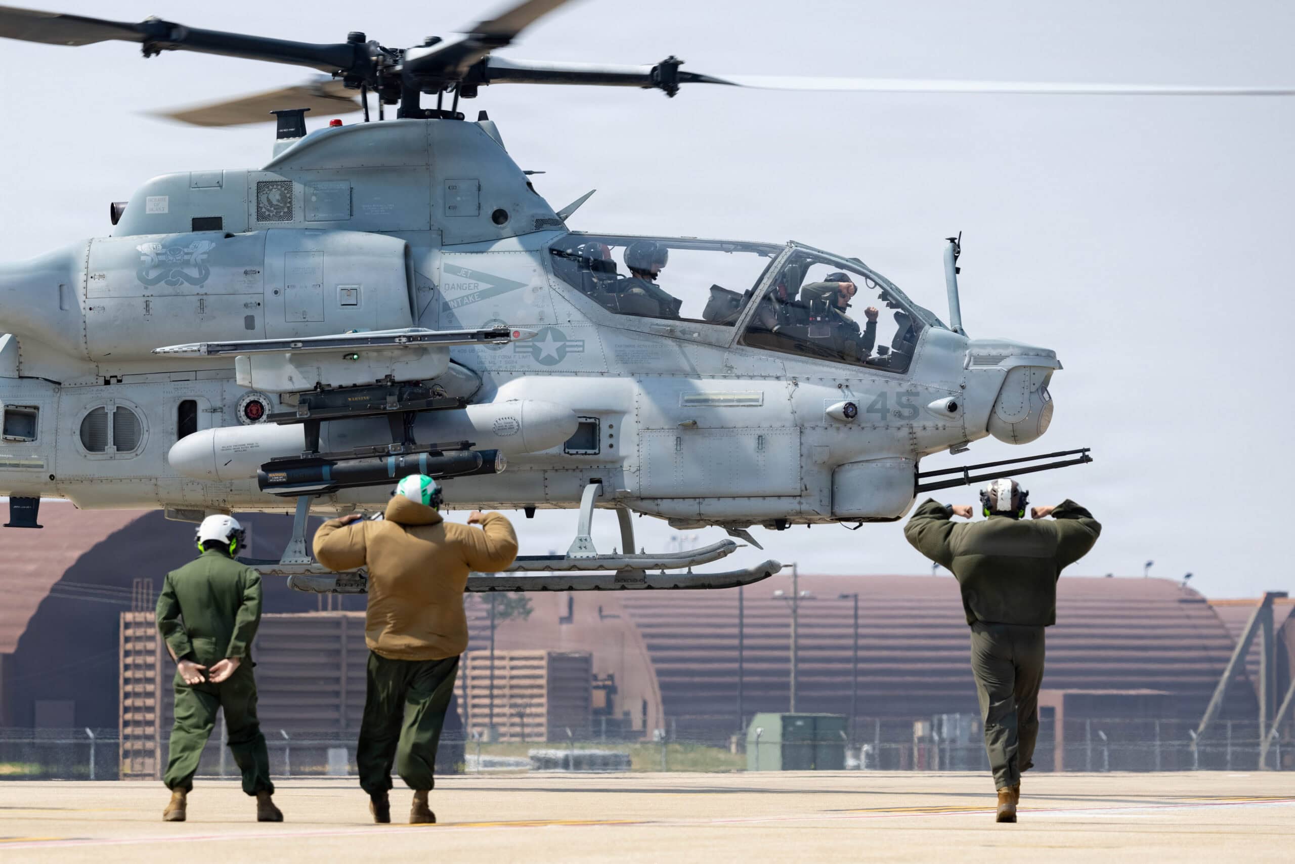 U.S. Marines with Marine Light Attack Helicopter Squadron 369, Marine Aircraft Group 36, 1st Marine Aircraft Wing signal to a departing AH-1Z Viper after Korean Marine Exchange Program 26.1 on Osan Air Base, Gyeonggi-do, South Korea after Korean Marine Exchange Program 26.1, April 2, 2026. KMEP is a semi-annual exercise that provides iterative opportunities for Republic of Korea Marine Corps and U.S. Marine Corps units to train together, improving their combined capabilities to deter threats and maintain peace on the Korean Peninsula. (U.S. Marine Corps photo by Lance Cpl. Carlos Paz-Sosa)