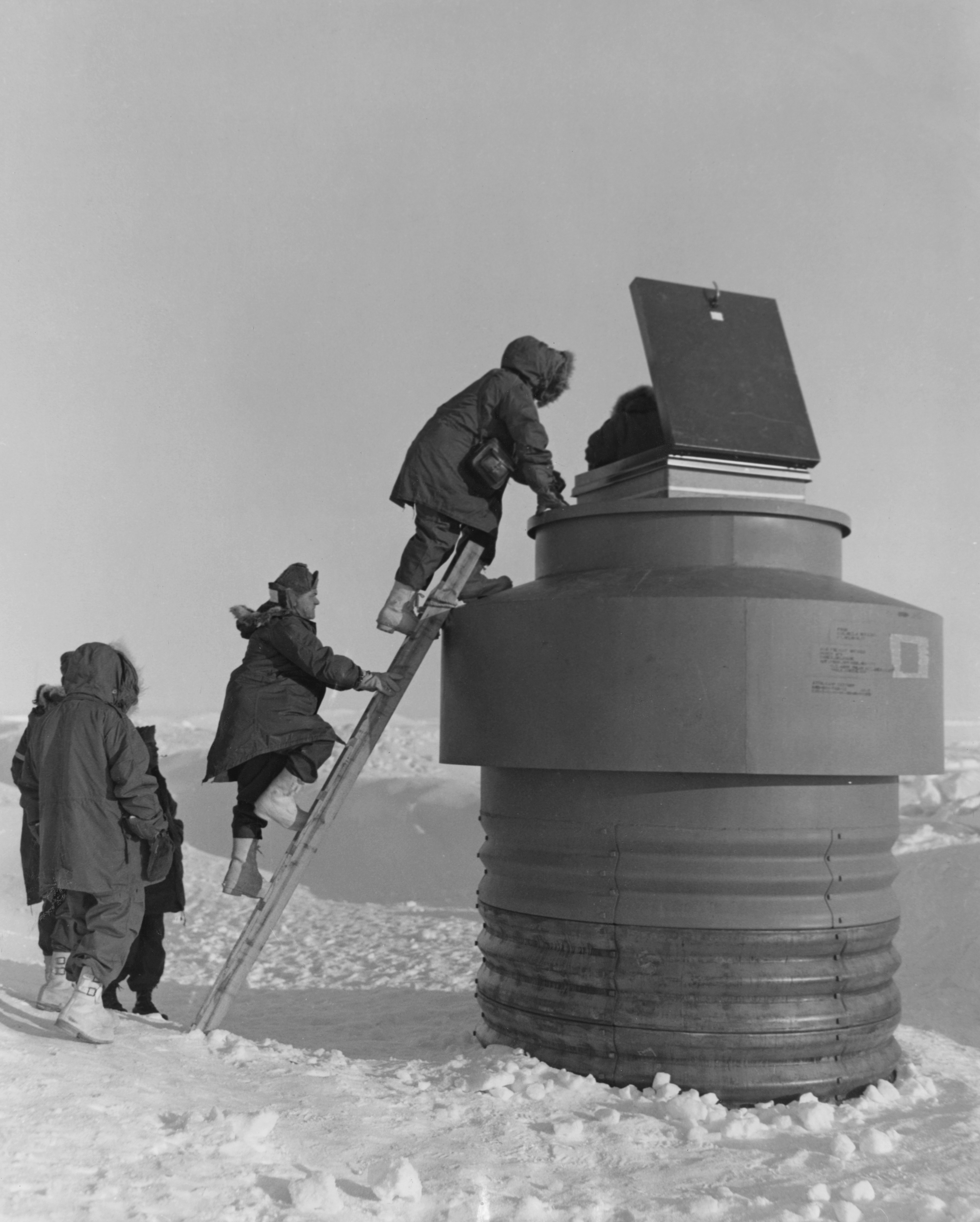 U.S. Army Col. Walter Parsons, center, and visitors climb up to an escape hatch to enter Camp Century, an Arctic U.S. military scientific research base in Greenland, June 1959. (U.S. Army/Pictorial Parade/Archive Photos/Getty Images)