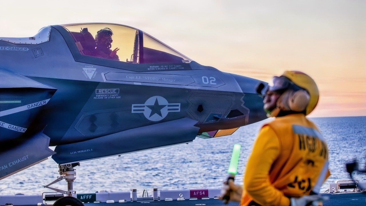 Chief Aviation Boatswain’s Mate (Handling) Stephane Togue, assigned to Wasp-class amphibious assault ship USS Makin Island (LHD 8), prepares to signal an F-35B Lightning II, attached to Marine Fighter Attack Squadron 211, for takeoff, Dec. 4, 2025. Makin Island is currently underway conducting routine operations in the U.S. 3rd Fleet. (Photo by Mass Communication Specialist Seaman Abraham Ramirez)