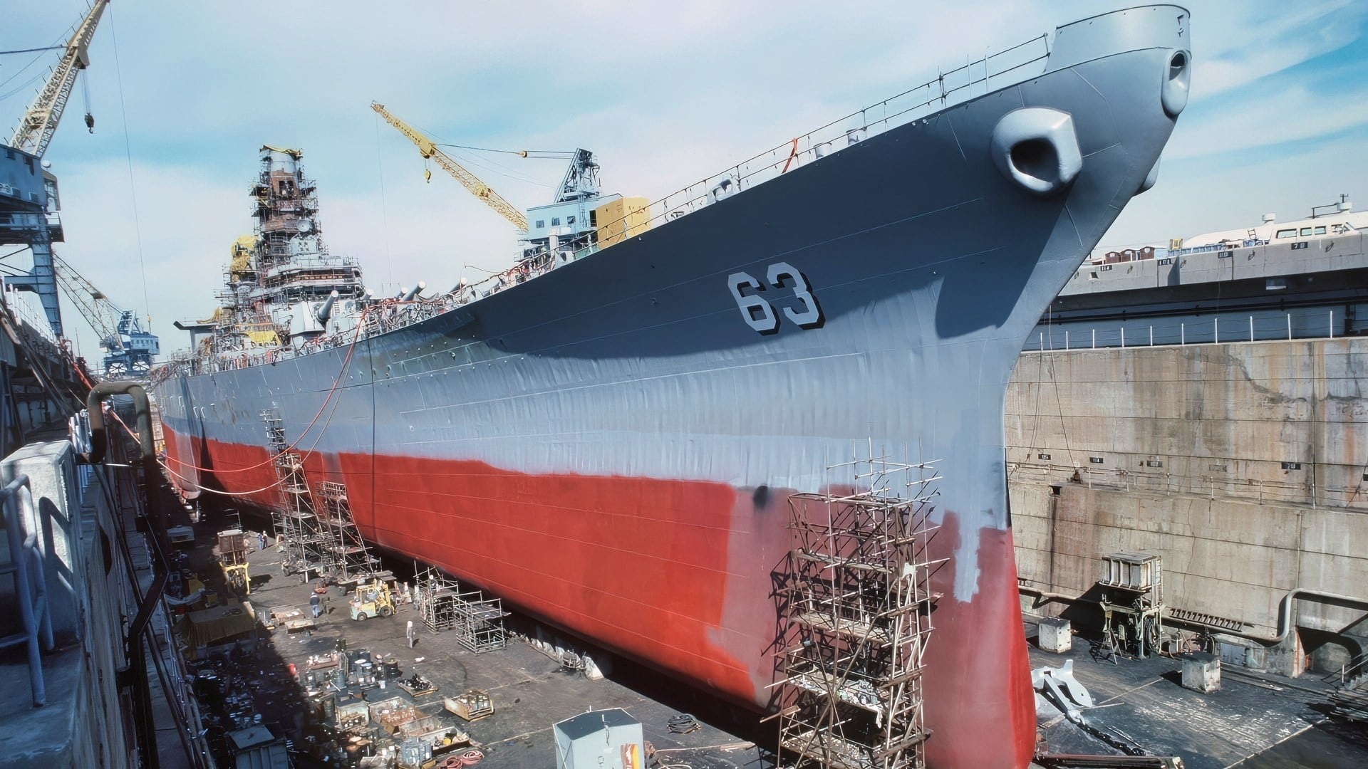 A starboard bow view of the battleship USS MISSOURI (BB 63) in dry dock for reactivation/modernization work prior to recommissioning.