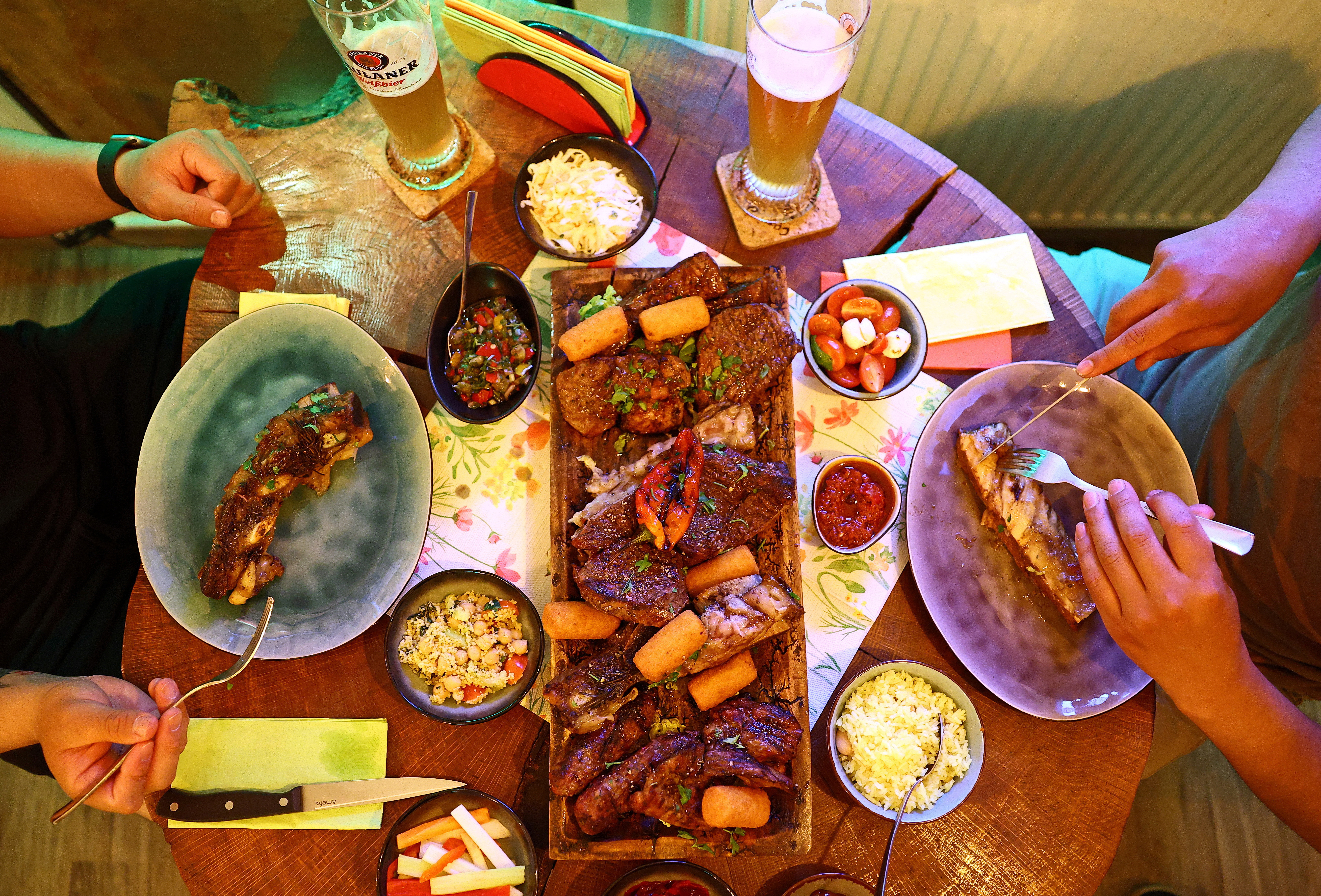 U.S. Army soldiers share an evening dinner at the Casa do Brasil steakhouse, after they returned from a field exercise in Schlicht near Vilseck, Germany, on May 5, 2026. (Lisi Niesner/Reuters)