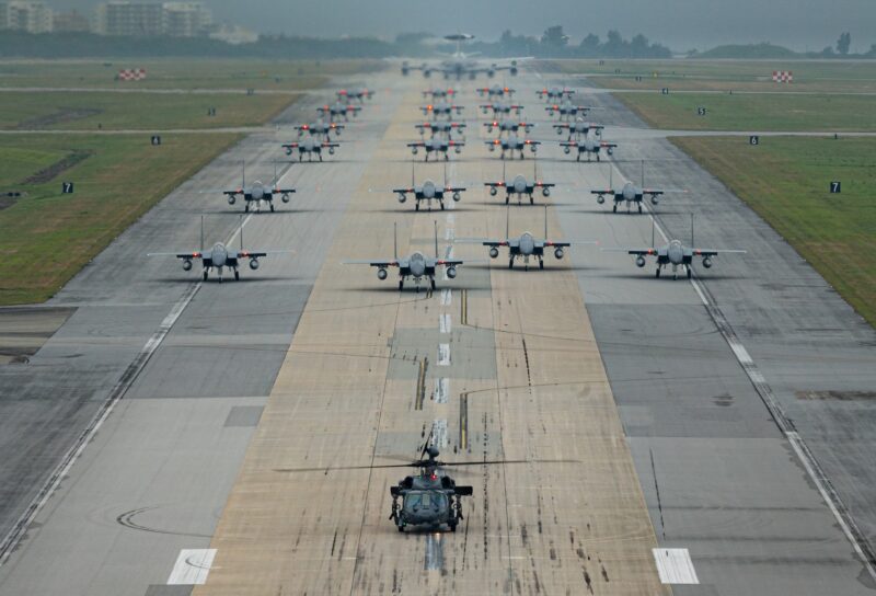 A formation of F-15C/D Eagles assigned to the 44th and 67th Fighter Squadrons, a KC-135 Stratotanker assigned to the 909th Air Refueling Squadron, an E-3 Sentry assigned to the 961st Airborne Air Control Squadron, and an HH-60 Pavehawk assigned to the 33rd Rescue Squadron taxi during a routine wing readiness exercise at Kadena Air Base, Japan, March 2, 2022. The large formation movement was part of a routine exercise scenario that tested the 18th Wing’s ability to generate airpower in support of the defense of Japan and other partner nations, ensuring the stability and security of a free and open Indo-Pacific. (U.S. Air Force photo by Senior Airman Stephen Pulter)