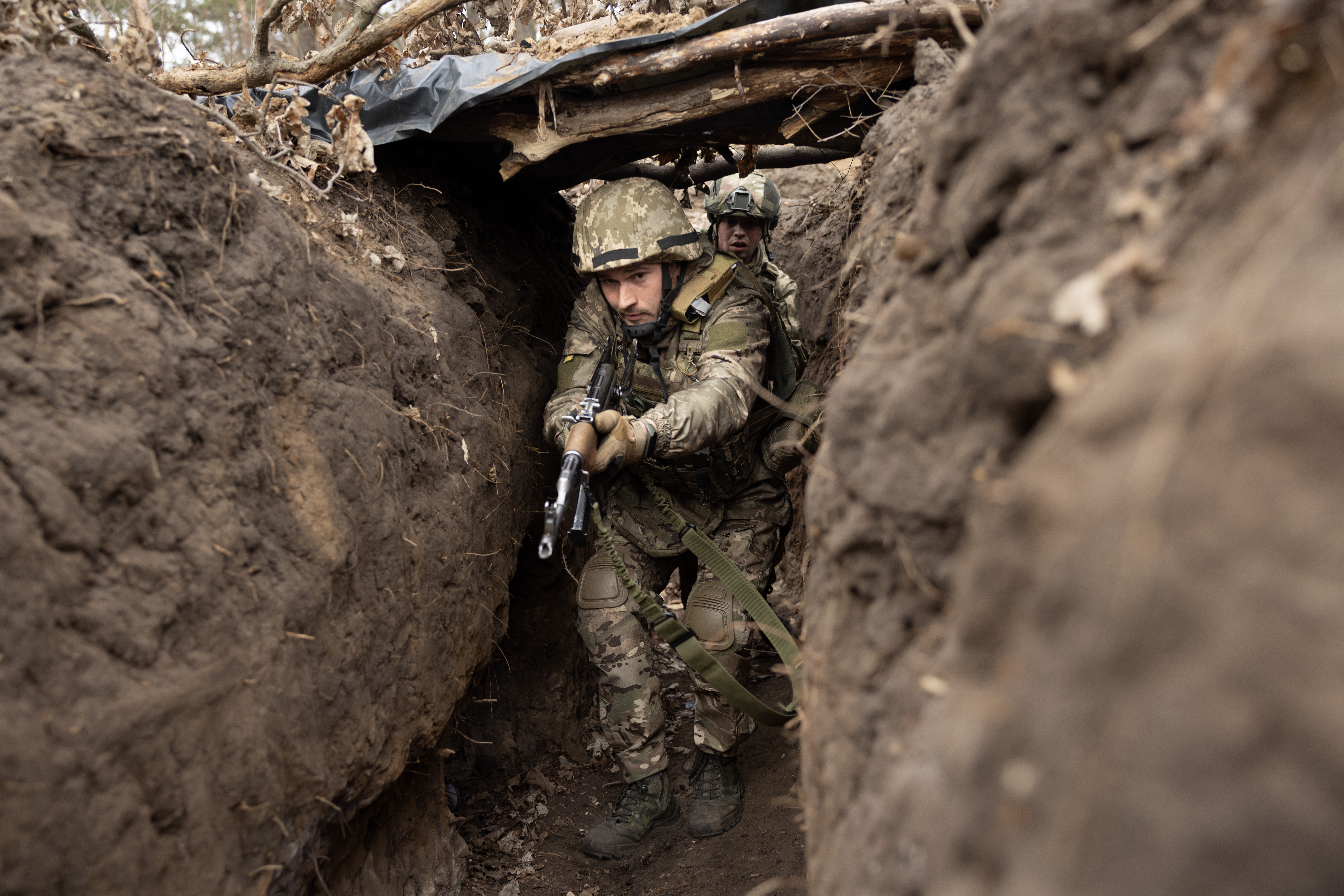 Newly recruited Ukrainian soldiers practice in a trench during military training on March 13, 2025, in Dnipropetrovsk, Ukraine. (Paula Bronstein/Getty Images)