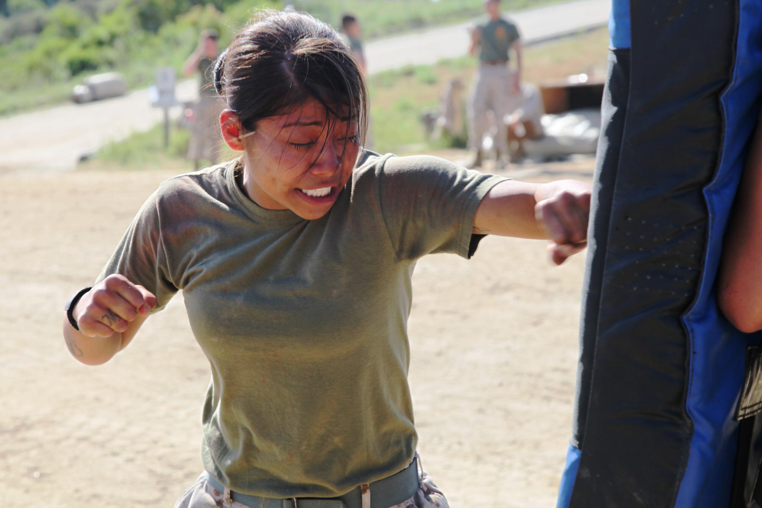 Cpl. Marisol Vargas, administrative clerk, Headquarters Detachment, Combat Logistics Battalion 11, Combat Logistics Regiment 17, 1st Marine Logistics Group, performs Marine Corps Martial Arts Program techniques after being sprayed with Oleoresin Capsicum during a training session at Camp Pendleton, Calif., April 15. The OC spray, commonly referred to as pepper spray, is considered a non-lethal weapon used by military policemen to restrain aggressive individuals refusing to cooperate.