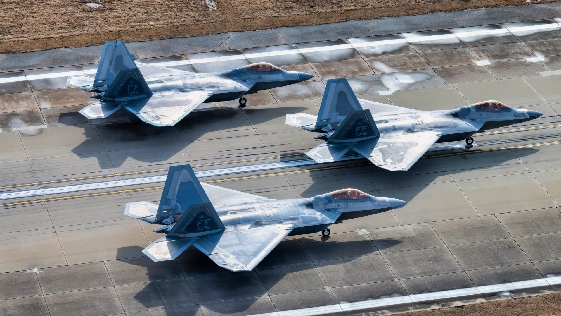 LANGLEY AIR FORCE BASE, Va. – F-22 Raptors from the 1st Fighter Wing sit in position on the runway fduring the Elephant Walk at Langley Air Force Base, Virginia, Jan. 31, 2025. The surge was designed to showcase the wing’s operational readiness and its ability to rapidly mobilize airpower. The 1st FW operates F-22 Raptors and T-38 Talons, maintaining combat capabilities that enable the U.S. Air Force to execute missions across the globe. With a focus on air superiority, the 1st FW plays a critical role in defending the nation’s interests. (U.S. Air Force photo by Tech Sgt. Matthew Coleman-Foster)
