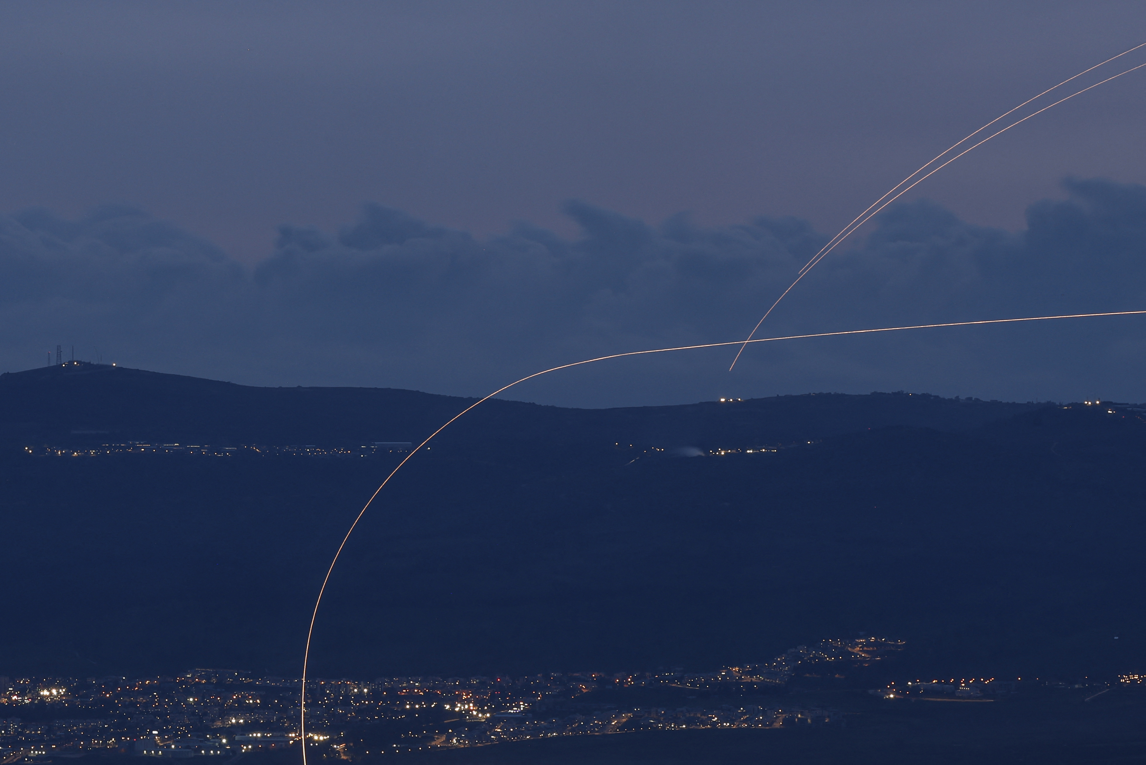 Rocket and interceptor trails over northern Israel night sky