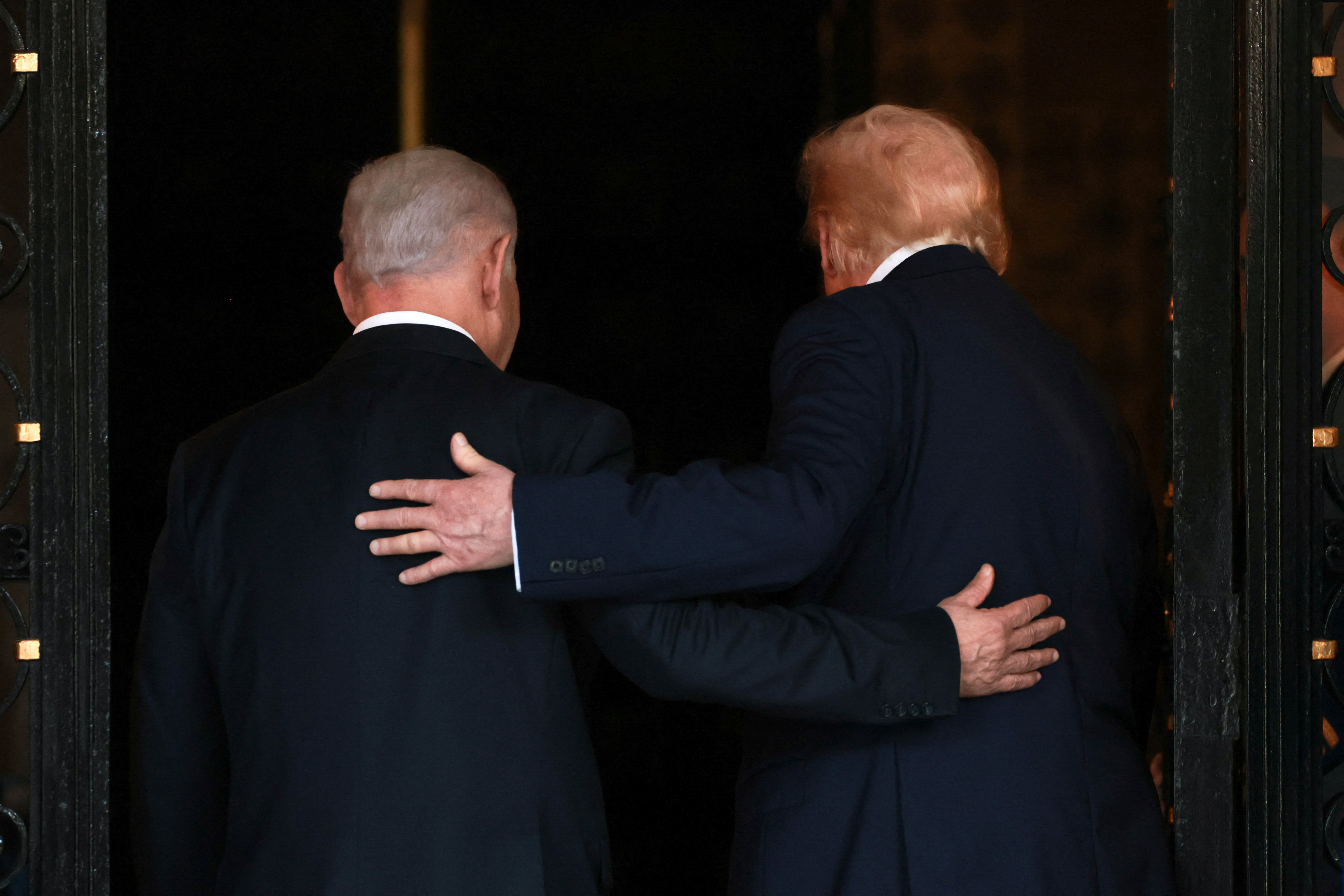 President Donald Trump and Israeli Prime Minister Benjamin Netanyahu embrace as they walk into Trump's Mar-a-Lago club in Palm Beach, Florida, in 2025. (Jonathan Ernst/Reuters)