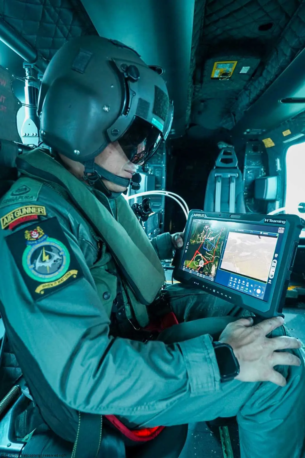 A crew member aboard the RSAF H225M receives real-time reconnaissance data froma Flexrotor drone on a tablet  [Photo © Airbus]