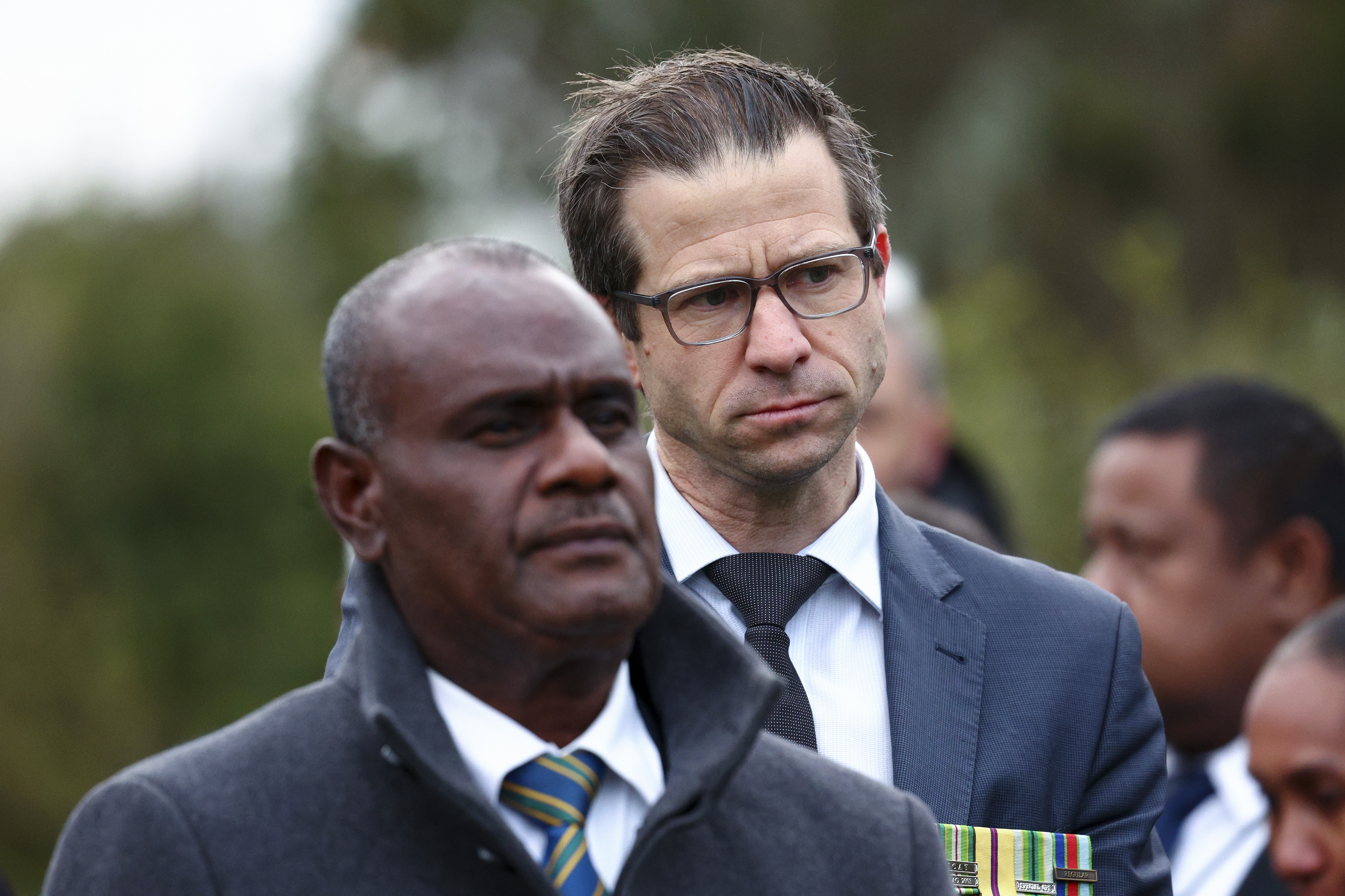 Solomon Islands Prime Minister Jeremiah Manele (L) and then-Minister for Veterans Chris Penk look on during a Wreath Laying Ceremony at Pukeahu National War Memorial Park on July 31, 2025, in Wellington, New Zealand. (Hagen Hopkins/Getty Images)
